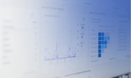 Close-up of a digital screen displaying financial line graphs and data analytics dashboards