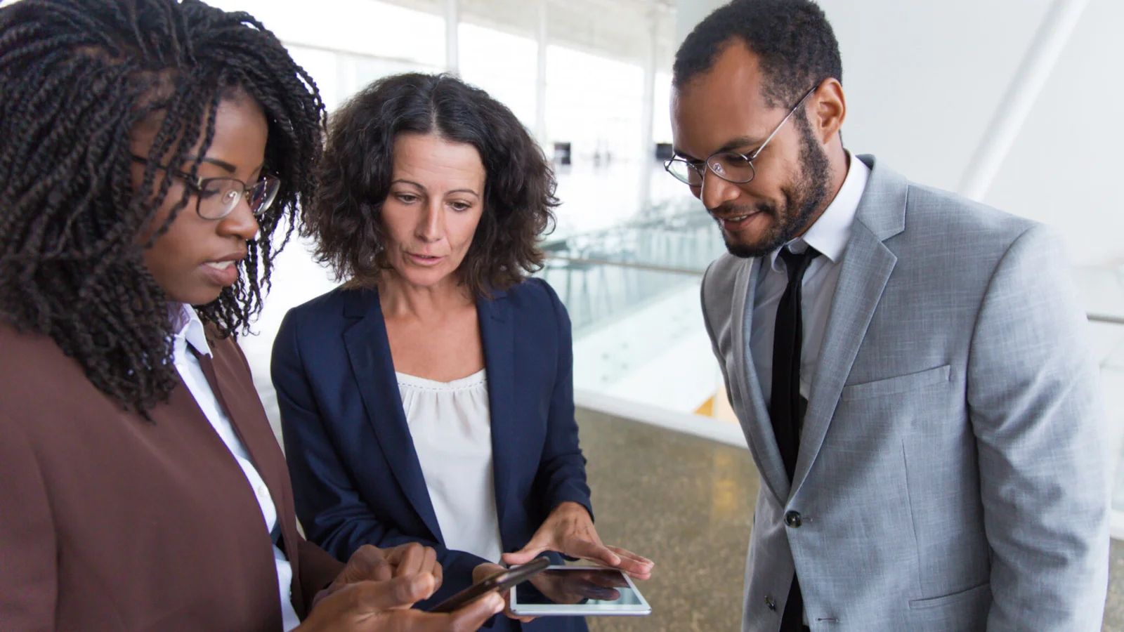 Business professionals analysing data on tablet together