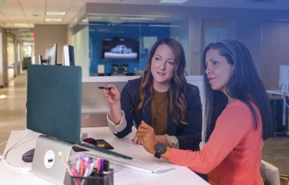 Professionals reviewing financial data on desktop computer