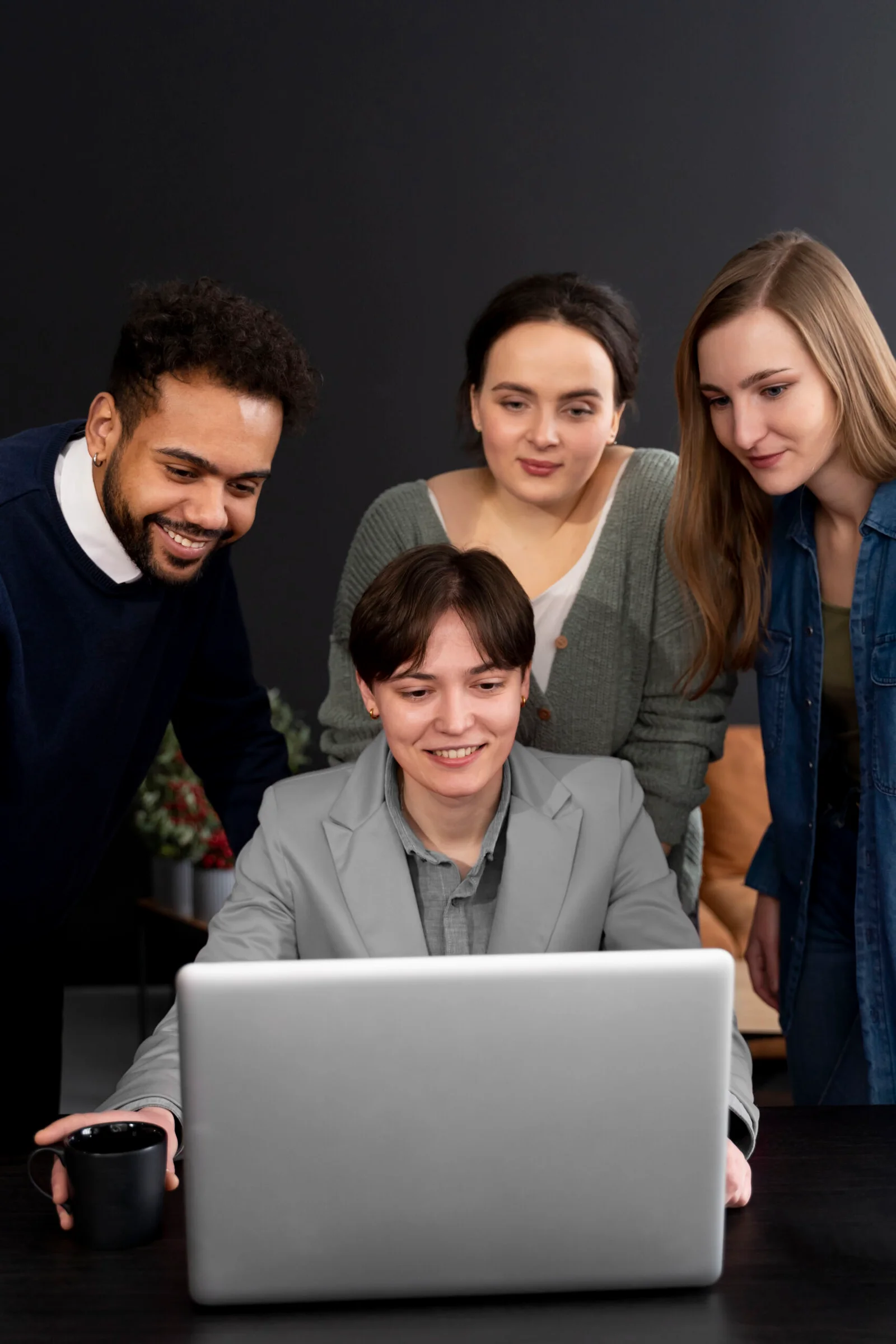 Team analysing financial data together on laptop