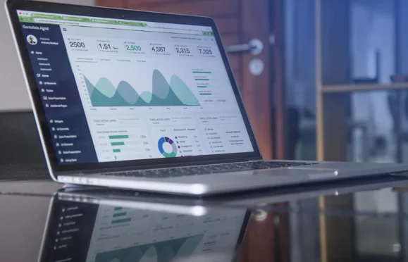 Laptop displaying financial dashboard with charts and metrics